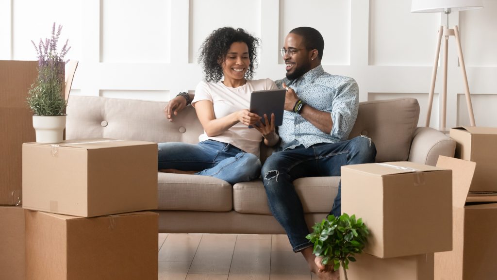 a couple using a tablet on moving day